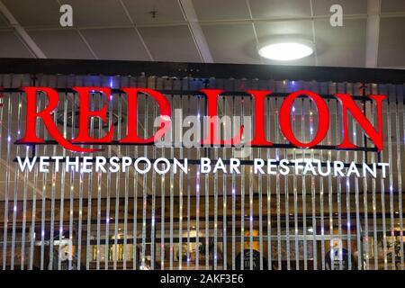 Firma / segnaletica presso il Red Lion Wetherspoon / Wetherspoons Pub / ristorante / Public House, presso l'aeroporto di Londra Gatwick North Terminal, Crawley. REGNO UNITO. (115) Foto Stock