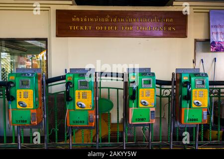 Bangkok/Thailandia-Dicembre 2019:cabine telefoniche vecchie verdi e gialle in fila presso la biglietteria degli stranieri alla stazione ferroviaria di Hua Lamphong. Foto Stock