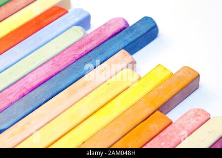 Pastelli colorati su sfondo bianco. Foto Stock