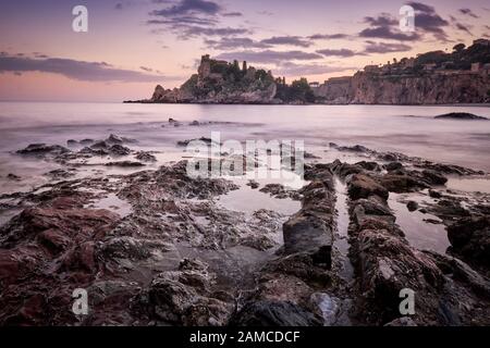 Bellissima isola al tramonto incorniciata da rocce incredibili, Isola Bella, Taormina, Sicilia, Italia Foto Stock