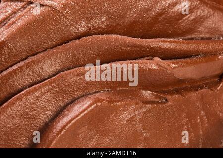Cioccolato che scorre, macro shot con delizioso cioccolato riscaldato. Foto Stock