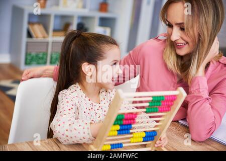 Ragazza felice che impara contare a casa Foto Stock