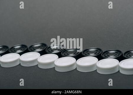 Linee di pedine bianche e nere isolate su grigio Foto Stock