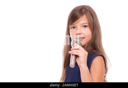 Bambina in posa con un microfono per cantare su sfondo bianco. Foto Stock