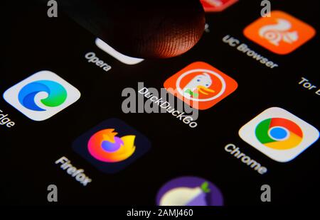 App browser Internet DuckDuckGo circondata da concorrenti e un dito dell'utente che lo seleziona. Concetto di concorrenza. Foto macro. Foto Stock