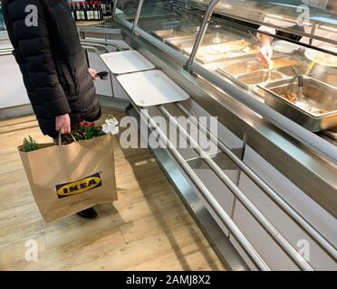 Parigi, Francia - 1° dicembre 2018: Vista laterale di una donna irriconoscibile in attesa in coda al banco del ristorante IKEA in attesa di ordinare polpette svedesi Foto Stock