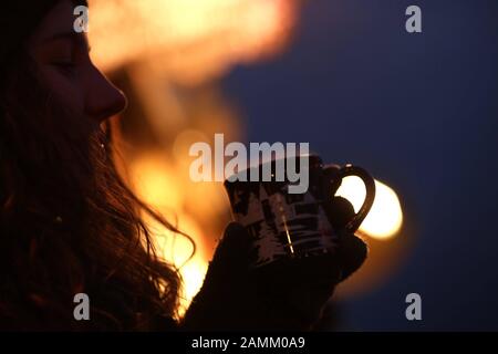 Donna con VIN brulé al Tollwood Winter Festival sul Theresienwiese. [traduzione automatizzata] Foto Stock