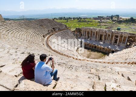 I turisti guardano l'antico teatro della città romana di Hierapolis a Pamukkale, Turchia. Foto Stock