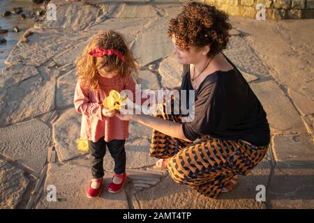 Madre dando a sua figlia un fiore, Brasile Foto Stock