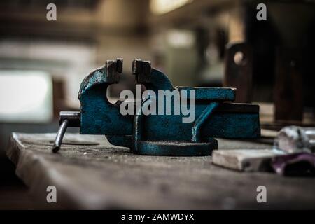 Morsa da banco vecchia e arrugginita in officina Foto Stock