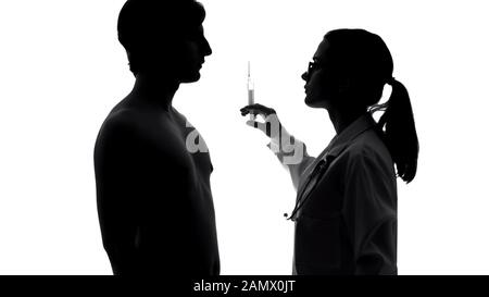 Medico femminile o infermiere che somministrano iniezione o vaccino a pazienti maschi, salute Foto Stock