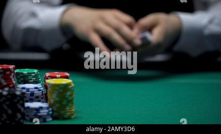 Professional croupier casinò carte shuffling prima del gioco di poker, sfondo Foto Stock