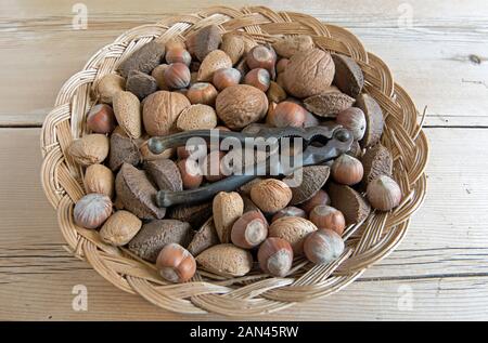 I dadi misti, Noce, Bazil e nocciole, nel cesto di vimini con dado vintage cracker. Foto Stock