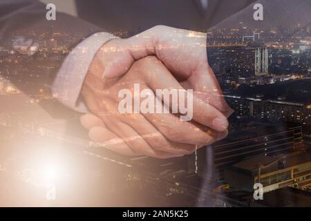 Doppia esposizione di uomini di affari che stringono le mani per finire un meeting handshake imprenditore di successo. Foto Stock
