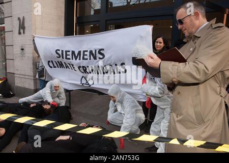 Londra, UK: 16 gennaio 2020. Estinzione della ribellione in scena un die-in, completa con un detective e il team di forensic ufficiali, al di fuori di Siemens la sede centrale di Londra a causa del loro coinvolgimento nella Adani a cielo aperto della miniera di carbone in Australia, pur affermando di essere finalizzata ad andare carbonio neutro, contro la volontà dei popoli indeginous, e nel contesto dell'Australia bushfires terribile. Credito: Anna Watson/Alamy Live News Foto Stock