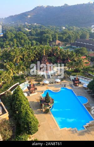 Vista di Mandalay Hill dietro i giardini e i dintorni del Mandalay Hill Resort hotel con la sua pagoda e piscina, Mandalay Myanmar (Birmania) Foto Stock