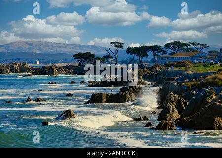 Surf che si infrangono sulle rocce Foto Stock