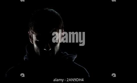Dangerous anonimo maschio nel buio della notte, spaventoso terrorismo per preparare la criminalità Foto Stock