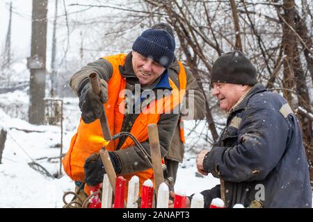 Lavoratori nei servizi municipali sono la riparazione di un tubo rotto. Foto Stock