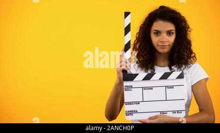 Bella afro-americane donna azienda battaglio bordo, le riprese video, audition Foto Stock