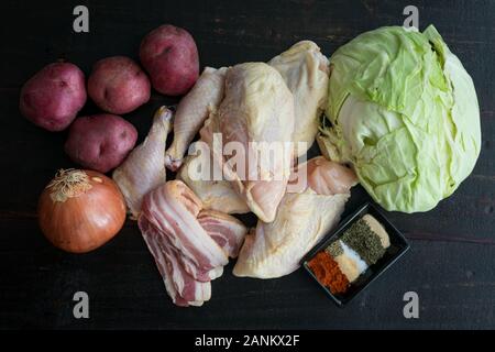 Irish pollo con cavolo, patate, cipolla e pancetta Ingredienti: pezzi di pollo, verdure fresche e spezie usate per effettuare una cottura Piatto di pollo Foto Stock