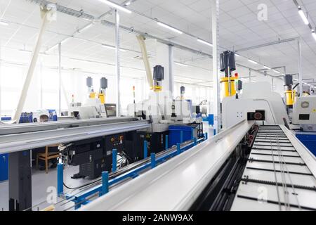 Un colpo interno della linea di produzione di parti metalliche nel moderno impianto Foto Stock