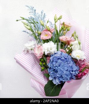 bouquet di bellissimi fiori eustoma, hydrangeas e altri fiori su sfondo chiaro, primo piano Foto Stock