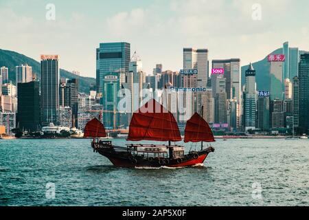 HongKong, Novembre 2019: Tradizionale, vecchia barca a vela sul Victoria Harbour con skyline di Hong Kong Island Foto Stock