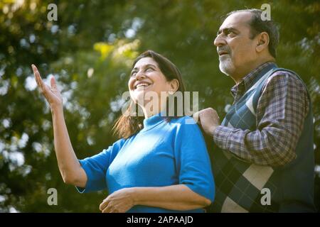 Coppia senior che ammirano qualcosa di estremo nel parco Foto Stock