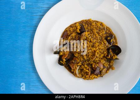 Piatto di paella tipica spagnola in legno blu Foto Stock