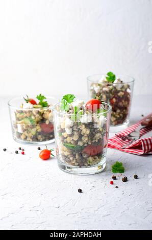 Insalata di lenticchie Bulgur con feta e Verdure Fresche in un bicchiere Foto Stock