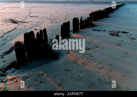 decadente onda di legno break su una spiaggia di sabbia Foto Stock