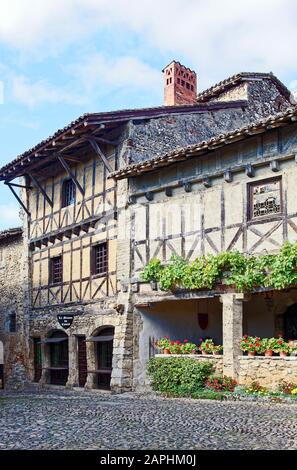 Vecchi edifici, a graticcio, pietra, strada acciottolata, fiori, borgo medievale murato, 14-15 secolo, Perouges, Francia, estate; verticale Foto Stock