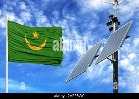 Pannelli solari sullo sfondo del cielo blu con un flagpole e la bandiera della Mauritania Foto Stock