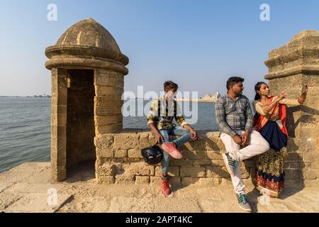 Diu, India - Dicembre 2018: Un ritratto candido di turisti che si fanno selfie dalle mura dell'antico forte marittimo costruito in Portogallo. Foto Stock