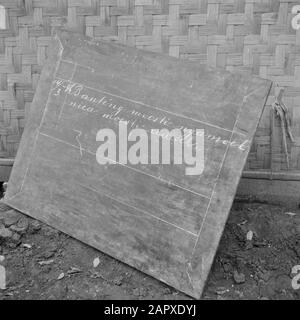 Volontari di guerra a Malacca e Indonesia Blackboard in una scuola di kampong. L'iscrizione recita: Santeng moesti ngamoek nica moesti remoek la carne selvatica deve essere feroce la nica sarà schiacciata Annotazione: Nica sta per Netherlands Indies Civil Administration Data: Marzo 1946 luogo: Indonesia, Indonesia, Java, Dutch East Indies Parole Chiave: Education Foto Stock