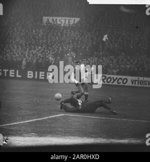 DWS contro Feyenoord 2-0, Keeper Jongbloed di DWS si lancia a palla di fronte al Guus Haak in arrivo, dietro di lui Burgers (DWS) Data: 5 gennaio 1964 posizione: Amsterdam, Noord-Holland Parole Chiave: Sport, calcio Nome personale: Cittadini, Joop, Hook, Guus, Jongbloed, Jan Foto Stock
