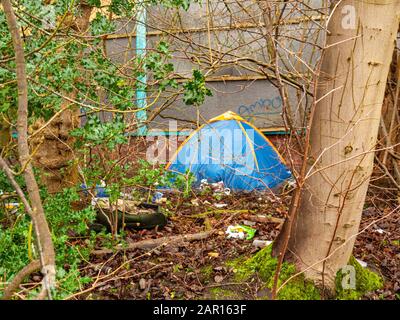 Tenda, in inverno, di una persona senza tetto circondata da pasticcio scartato nel centro della città di Crewe Cheshire UK Foto Stock