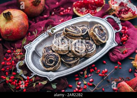 Rotolini di papavero vegano crudi con roseanca e semi di melograno in lo sfondo Foto Stock