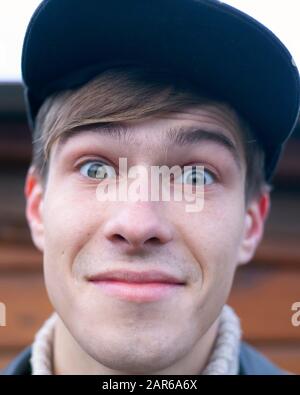 Ritratto di un giovane uomo sorridente di 20-21 anni in un berretto. Foto Stock