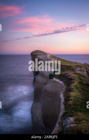 Tramonto sulla spiaggia di stunningTunnel, Nuova Zelanda Foto Stock