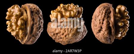 Set di noci a metà apertura con kernel isolato su sfondo nero Foto Stock