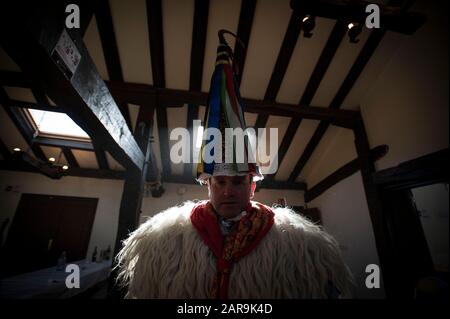 Un joaldunak pone durante il carnevale.Il suono delle campane si sente attraverso la valle Bidasoa, Ituren un piccolo villaggio situato nella regione di Malerreka, presages l'accoglienza dei carnevali lungamente attesi per tutti gli abitanti della regione. I Joaldunaks camminano per le strade vestite di sandali, petticavene sulla punta del piede, pelli di pecora sulla vita e sulle spalle, sciarpe colorful del collo, ttuntturroa (cappelli affusolati) e un bastoncino di cavallo sulla loro mano destra, suonano le loro campane facendo il loro suono rumble in tutta la valle, così guidando via gli spiriti maligni. Foto Stock