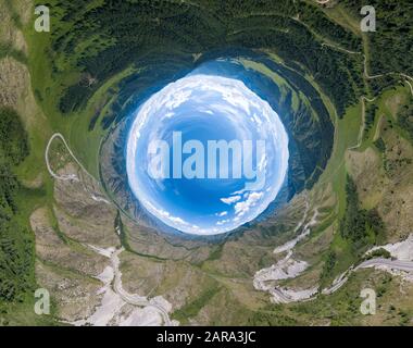 Immagine panoramica a 360 gradi di un mondo astratto girato all'interno con prati verdi intorno a un cielo ovale con nuvole nel passo Chike-Taman nel Altai m. Foto Stock