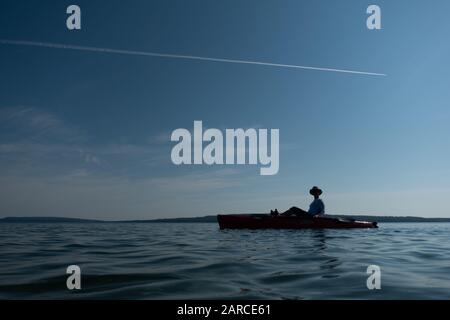 Silhouette di una persona in kayak sul lago Superior Foto Stock