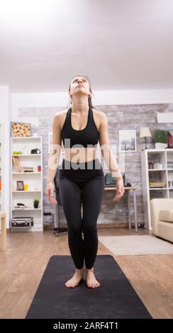 Donna caucasica che salta in aria esercizio a casa. Foto Stock