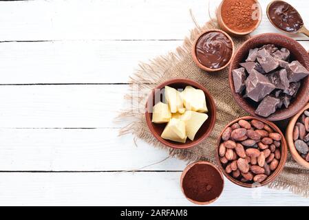 Cioccolato, cacao in grani, burro di cacao. Cioccolato Sfondo Vista Dall'Alto. Spazio libero di copia. Foto Stock