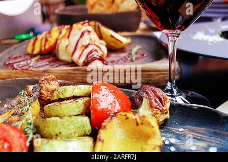 Pranzo semplice e gustoso con vino rosso e verdure alla griglia, selezione del fuoco Foto Stock