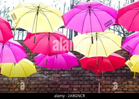 Ombrelloni aperti appesi alla corda nel famoso Camden Market di Londra Foto Stock