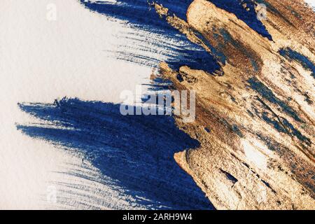 Tratti blu e oro disegnati a mano sulla carta. Sfondo astratto Foto Stock